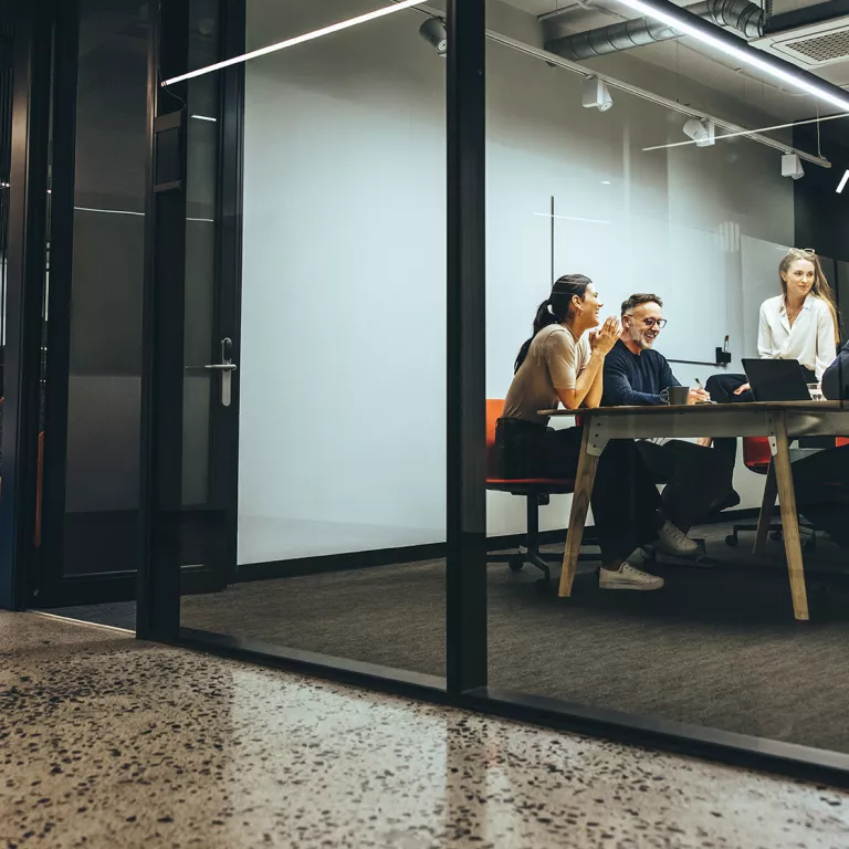 Team meeting in modern glass office